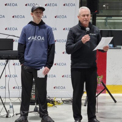 Youth in Action volunteers assisted AEOA Executive Director Mark Page during announcements.