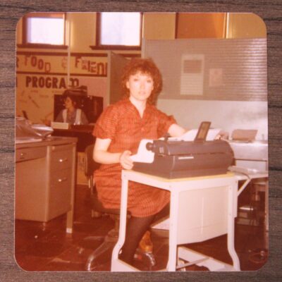 Marilyn Ocepek seated at a typewriter desk in AEOA’s nutrition department circa 1970.
