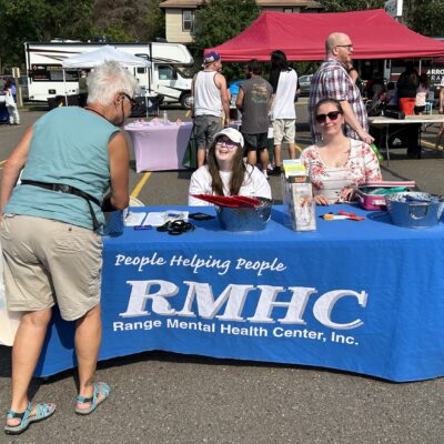 A block party visitor stops by the Range Mental Health Center table during AEOA’s 4th Annual Block Party in Virginia on Thursday, July 23, 2026.