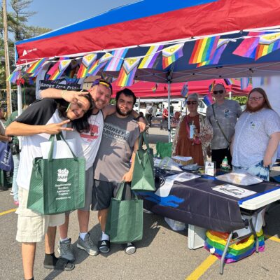 A few folks cheesin’ at Range Iron Pride’s table during AEOA’s 4th Annual Block Party in Virginia on Thursday, July 23, 2026.