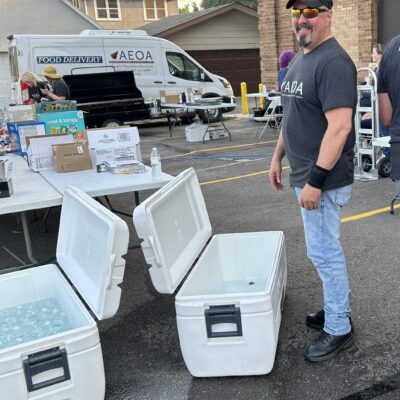 AEOA Custodian Richard Loushine helps refresh water coolers during the agency block party.