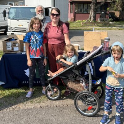 A family visits with AEOA’s Housing Services Director Dave Johnson at AEOA’s block party in Virginia on Thursday, July 23, 2026.